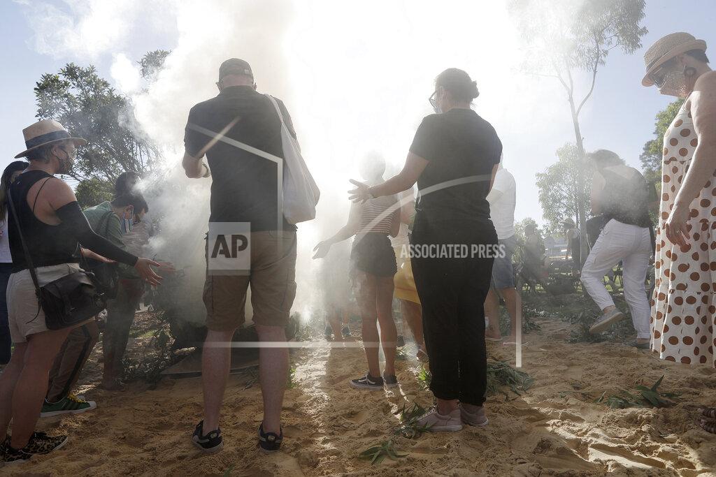 Rick Rycroft Members of the public participate in an Aboriginal smoking ceremony during Australia Day ceremonies in Sydney, Tuesday, Jan. 26, 2021. (AP Photo/Rick Rycroft)