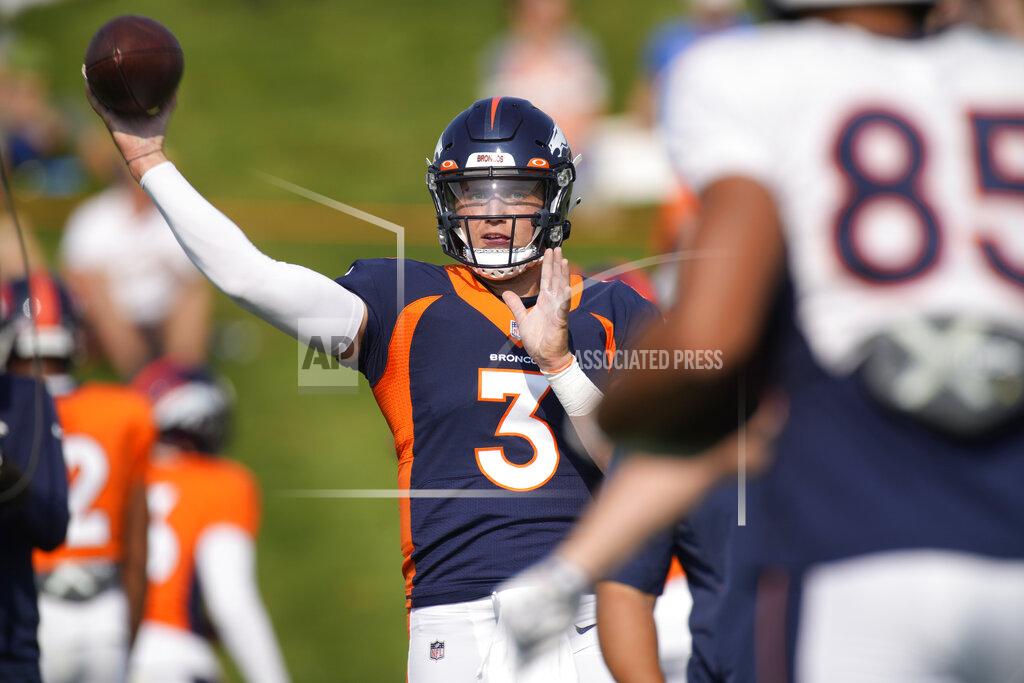Denver Broncos quarterback Drew Lock, back, passes the ball to tight end Albert Okwuegbunam as they take part in drills during an NFL football training camp at the team's headquarters Tuesday, Aug. 17, 2021, in Englewood, Colo. (AP Photo/David Zalubowski)