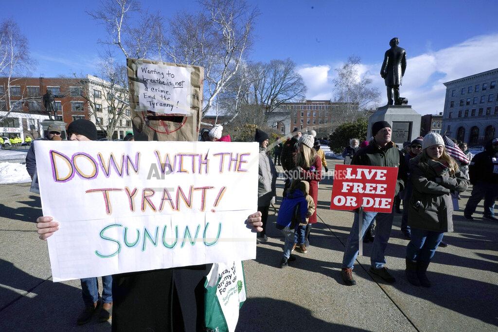 Charles Krupa FILE - In this Thursday, Jan. 7, 2021 file photo, people protest outside the Statehouse in Concord, N.H., as Gov. Chris Sununu is inaugurated at noon for his third term as governor. A measure that recently passed New Hampshire's Republican-led House would prohibit governors from indefinitely renewing emergency declarations, as Sununu has done every 21 days for the past year. It would halt emergency orders after 30 days unless renewed by lawmakers. (AP Photo/Charles Krupa)