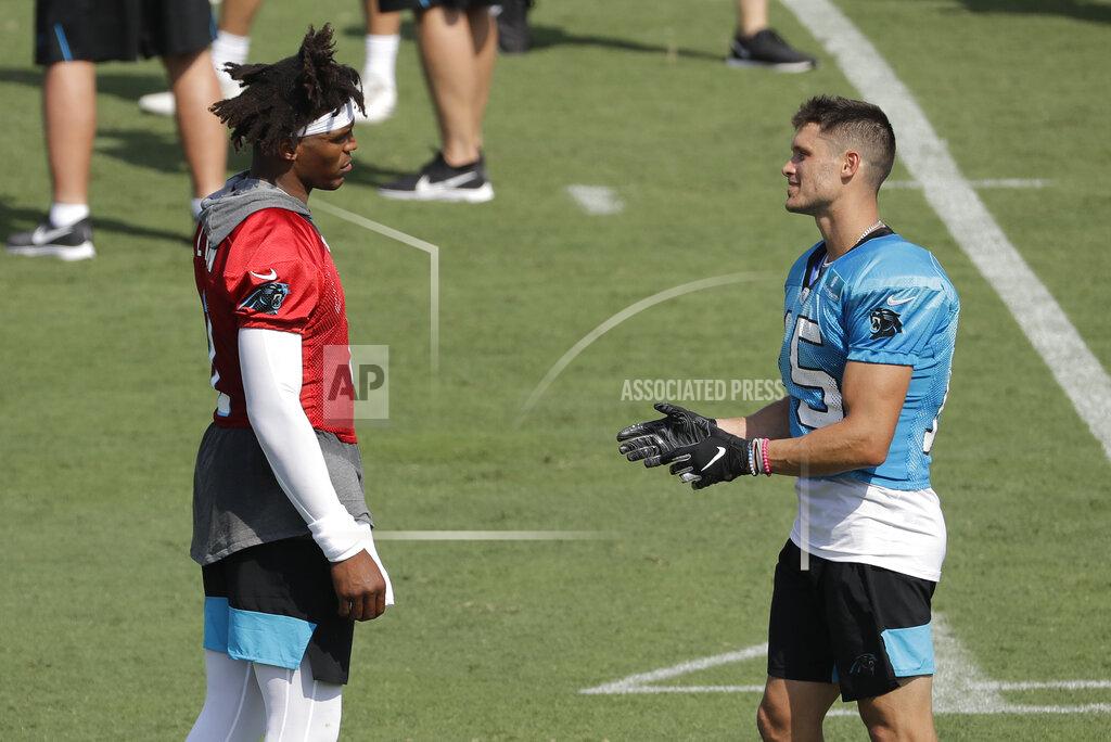 Chuck Burton Carolina Panthers quarterback Cam Newton, left, talks with Chris Hogan, right, during practice at the NFL football team's training camp in Spartanburg, N.C., Friday, July 26, 2019. (AP Photo/Chuck Burton)