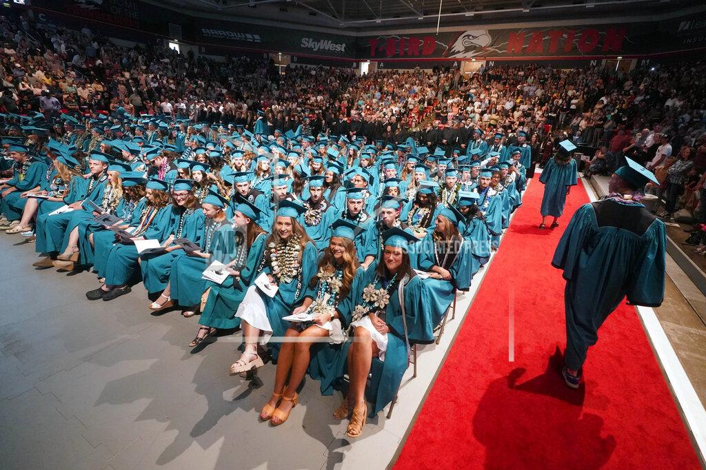 Rick Bowmer **HOLD AND MOVE WITH STORY**The Canyon View High School graduation is shown Wednesday, May 25, 2022, in Cedar City, Utah. Last year, two school principals in southern Utah's Iron County School District attempted to bar two Native American students from wearing forms of tribal regalia at their graduation ceremonies. One wore it anyway, daring school officials to follow through on the prohibition, while the other reported the incident to the chairwoman of the Paiute Indian Tribe of Utah, who then worked to ensure Native American students had the right to wear tribal regalia at their graduations under state law. (AP Photo/Rick Bowmer)