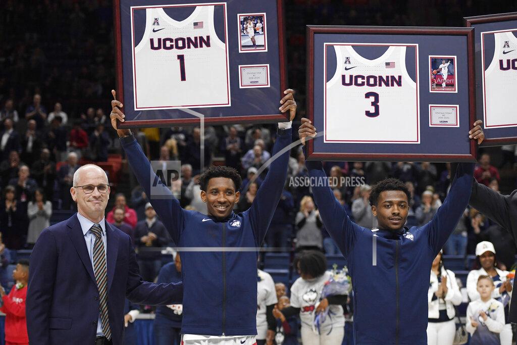 Jessica Hill Connecticut's Christian Vital (1) and Alterique Gilbert (3) stand by head coach Dan Hurley as they are honored on Senior Night before an NCAA college basketball game against Houston, Thursday, March 5, 2020, in Storrs, Conn. (AP Photo/Jessica Hill)