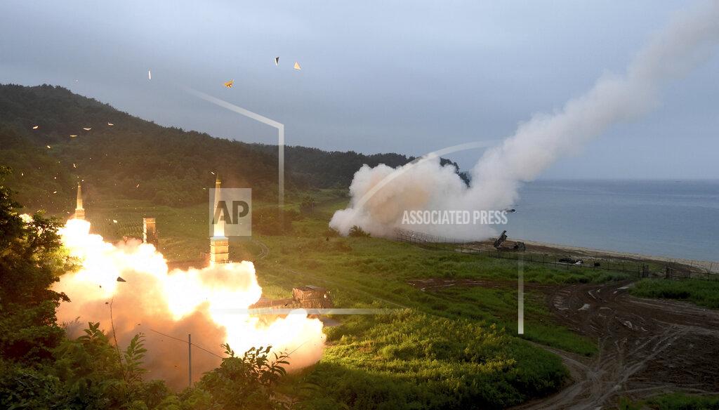FILE - In this July 29, 2017, file photo provided by South Korea Defense Ministry, South Korea's Hyunmoo II Missile system, left, and a U.S. Army Tactical Missile System, right, fire missiles during a combined military exercise between the two countries against North Korea at an undisclosed location in South Korea. South Korea said Tuesday, July 28, 2020, it has won U.S. consent to use solid fuel for space launch vehicles, a move that experts say would enable Seoul to launch its first surveillance satellites and accumulate technology to build more powerful missiles. (South Korea Defense Ministry via AP, File)