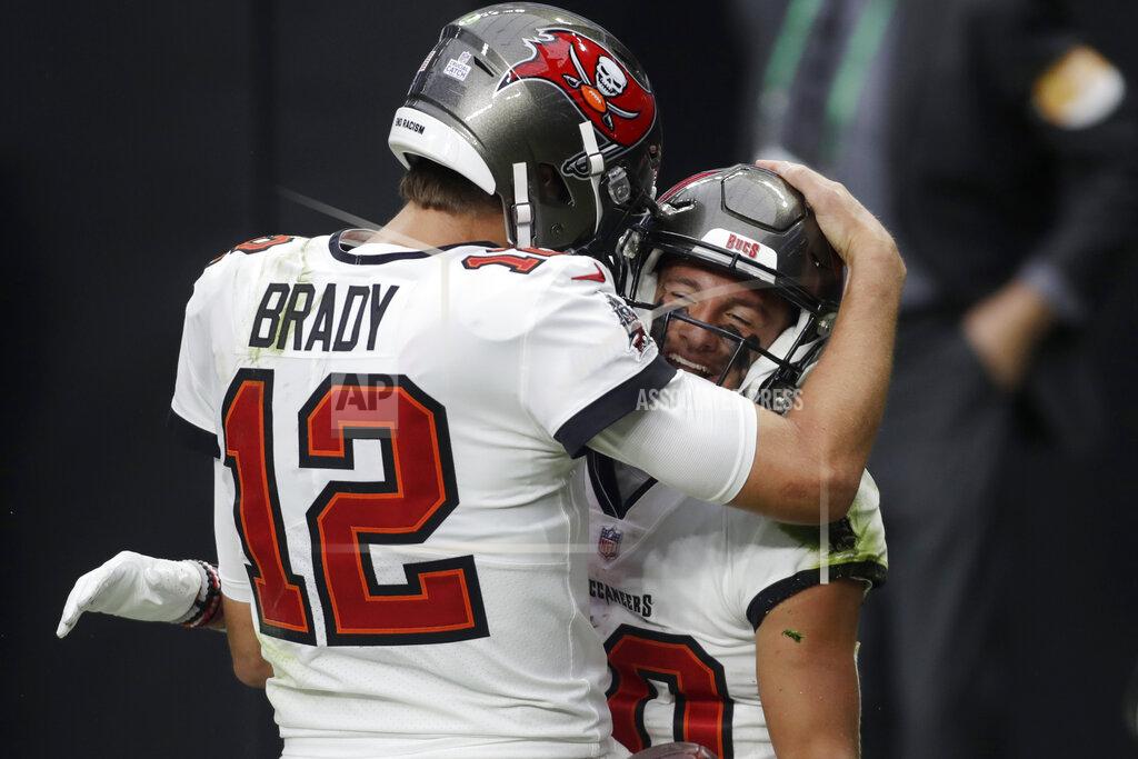 Isaac Brekken Tampa Bay Buccaneers quarterback Tom Brady (12) celebrates after making a touchdown pass to wide receiver Scott Miller, right, during the first half of an NFL football game, Sunday, Oct. 25, 2020, in Las Vegas. (AP Photo/Isaac Brekken)