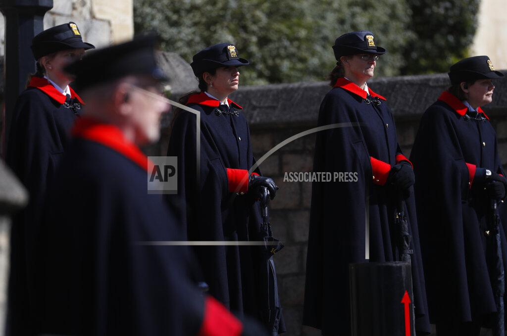 Alastair Grant Wardens and armed police guard the Henry VIII gate in Windsor, England, Friday, April 16, 2021. Prince Philip husband of Britain's Queen Elizabeth II died April 9, aged 99, his funeral will take place Saturday at Windsor Castle in St George's Chapel. (AP Photo/Alastair Grant)