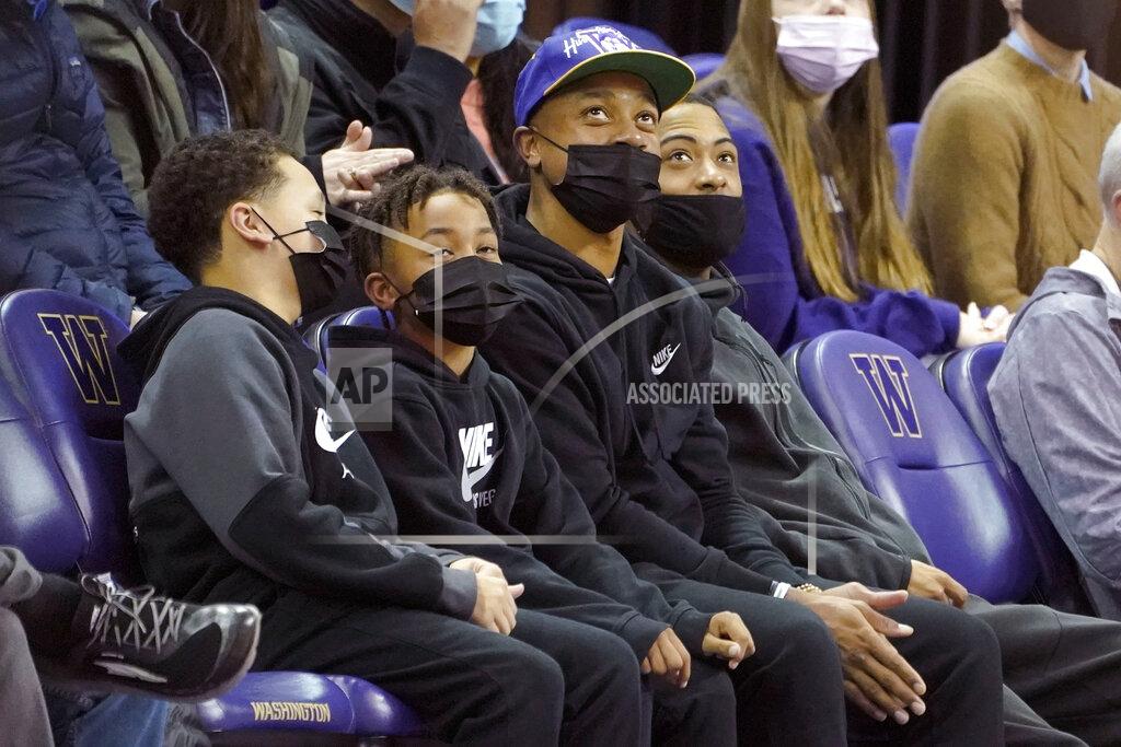 Ted S. Warren NBA basketball player Isaiah Thomas, third from left, a former guard with the University of Washington, sits courtside during an NCAA college basketball game between Washington and Colorado, Thursday, Jan. 27, 2022, in Seattle. (AP Photo/Ted S. Warren)