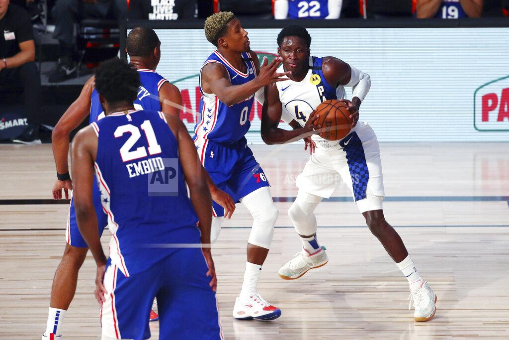 Kim Klement Indiana Pacers guard Victor Oladipo (4) handles the ball against Philadelphia 76ers guard Josh Richardson (0) during the second quarter of an NBA basketball game Saturday, Aug. 1, 2020, in Lake Buena Vista, Fla. (Kim Klement/Pool Photo via AP)
