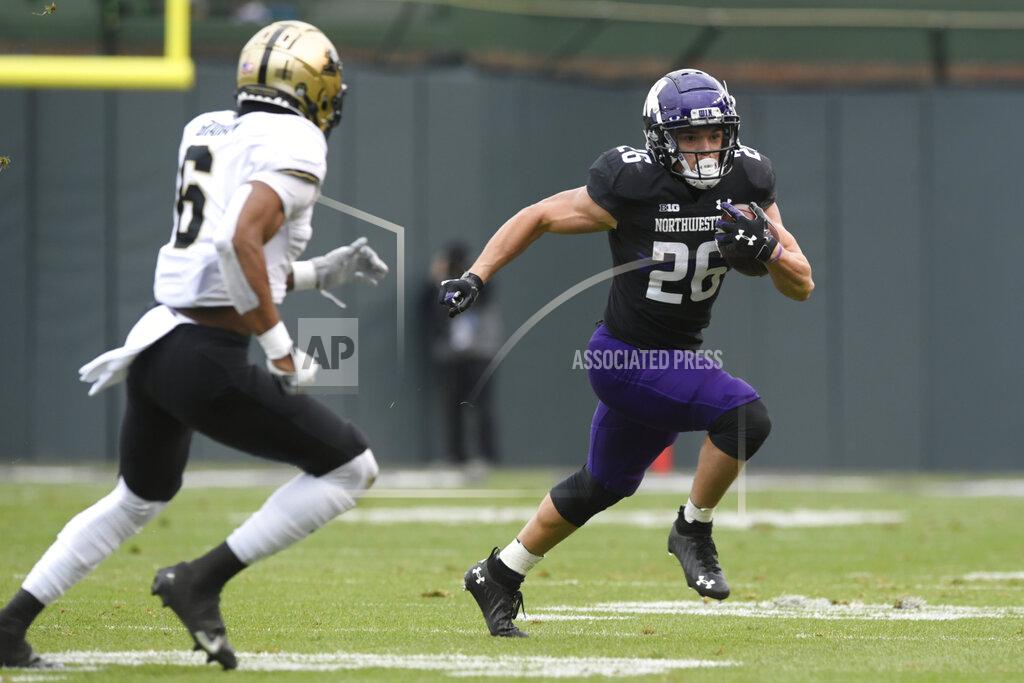 Paul Beaty Northwestern running back Evan Hull (26) rushes against Purdue's Jalen Graham (6) during the second half of an NCAA college football game, Saturday, Nov. 20, 2021 at Wrigley Field in Chicago. Purdue won 32-14. (AP Photo/Paul Beaty)