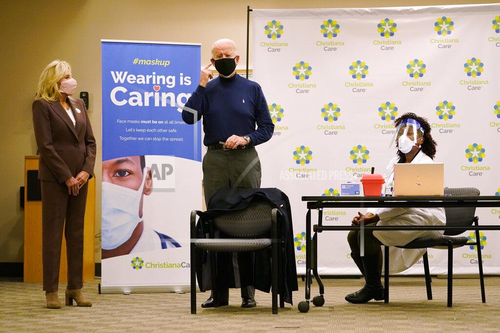 Carolyn Kaster President-elect Joe Biden speaks after receiving his first dose of the coronavirus vaccine from nurse practitioner Tabe Mase, right, at ChristianaCare Christiana Hospital in Newark, Del., Monday, Dec. 21, 2020, as Jill Biden looks on. (AP Photo/Carolyn Kaster)
