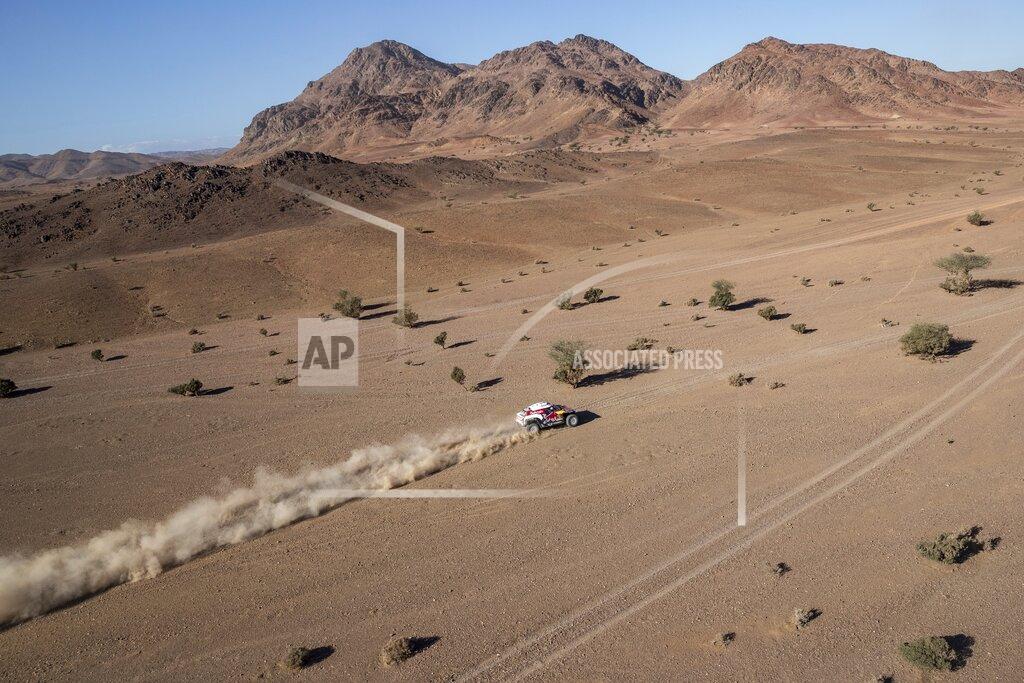 Bernat Armangue Driver Carlos Sainz, of Spain, and co-driver Lucas Cruz, of Spain, race their Mini during stage two of the Dakar Rally, between Al Wajh and Neom, Saudi Arabia, Monday, Jan. 6, 2020. (AP Photo/Bernat Armangue)