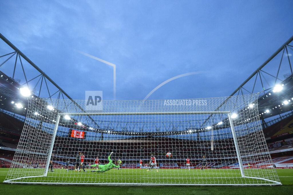 Glyn Kirk Arsenal's Reiss Nelson scores his team second goal during the English Premier League soccer match between Arsenal and Liverpool at the Emirates Stadium in London, England, Wednesday, July 15, 2020. (Glyn Kirk/Pool via AP)