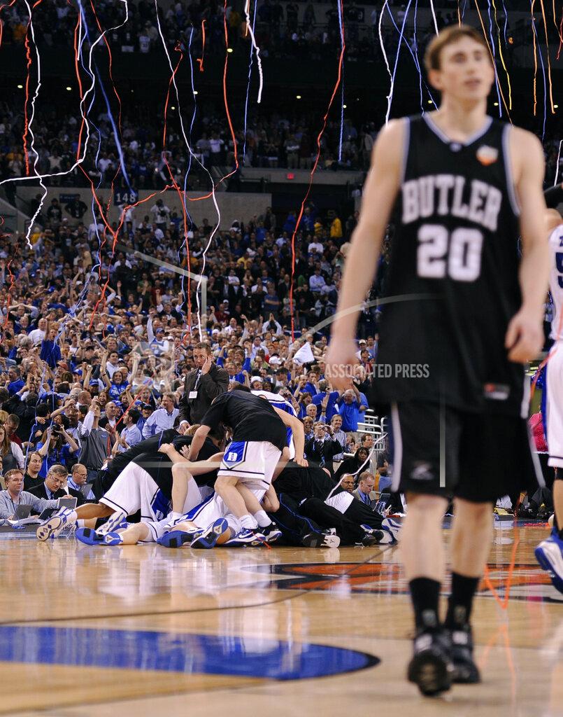 Mark J. Terrill FILE - In this April 5, 2010, file photo, Duke players celebrate as Butler's Gordon Hayward (20) walks off the court at the end of the men's NCAA Final Four college basketball championship game in Indianapolis. Duke won 61-59. (AP Photo/Mark J. Terrill, File)