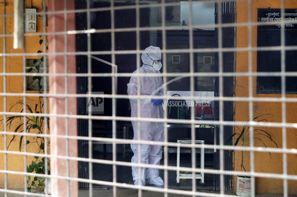 Rajanish Kakade A health worker waits to collect swab samples to test for COVID-19 at a government dispensary in Mumbai, India, Monday, Sept. 14, 2020. India's coronavirus cases are now the second-highest in the world and only behind the United States. (AP Photo/Rajanish Kakade)