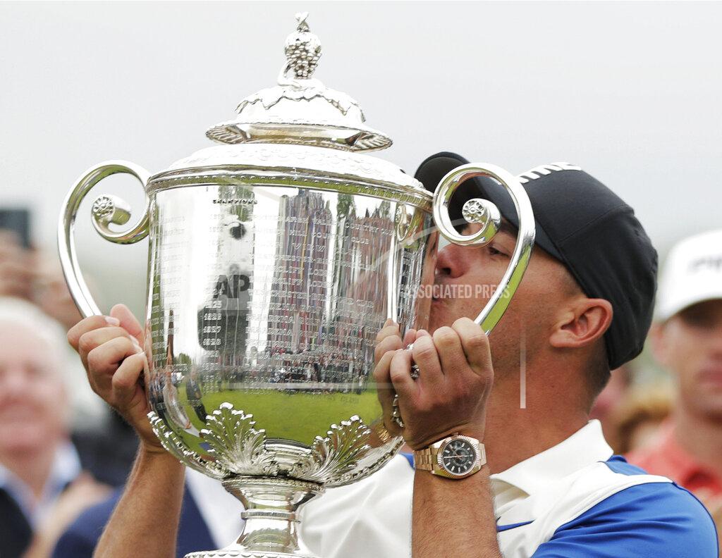 Julio Cortez File-This May 19, 2019, file photo shows Brooks Koepka kissing the Wanamaker trophy after winning the PGA Championship golf tournament, at Bethpage Black in Farmingdale, N.Y. (AP Photo/Julio Cortez, File)
