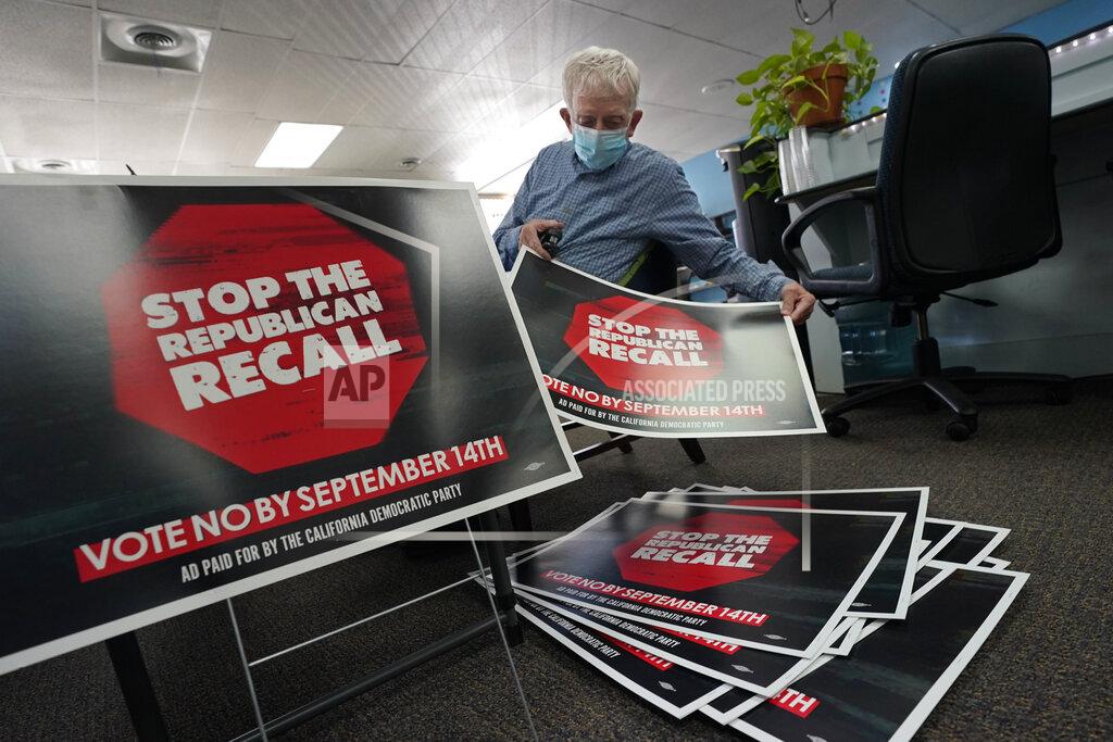 Rich Pedroncelli Volunteer Merle Canfield assembles yard signs against the Sept. 14, recall election of Gov. Gavin Newsom, at the Fresno County Democratic Party headquarters in Fresno, Calif., Thursday July 29, 2021. While Democratic registration almost doubles that of Republicans in the state, Democratic Party leaders fear Republicans appear more eager to vote. (AP Photo/Rich Pedroncelli))