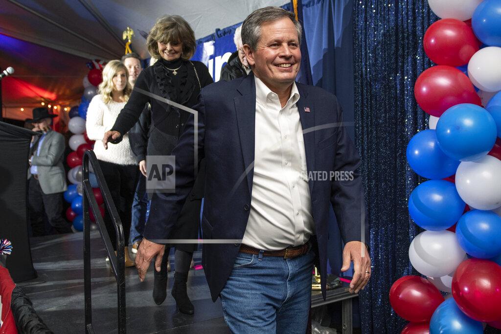 Tommy Martino CORRECTS DATE TO EARLY WEDNESDAY, NOV. 4 INSTEAD OF TUESDAY, NOV. 3 - Sen. Steve Daines, R-Mont., with his wife Cindy, arrives to address his supporters after his race was called by The Associated Press, early Wednesday, Nov. 4, 2020, in Bozeman, Mont. (AP Photo/Tommy Martino)