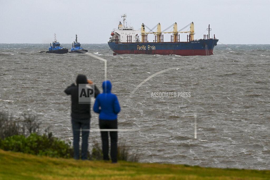 Dean Lewins The Portland Bay cargo ship is towed safely into Port Botany, Sydney, Wednesday, July 6, 2022. A bulk carrier that was stranded off the coast of Sydney since Monday has been safely towed back to Port Botany on Wednesday afternoon where its engine will be repaired. (Dean Lewins/AAP Image via AP)