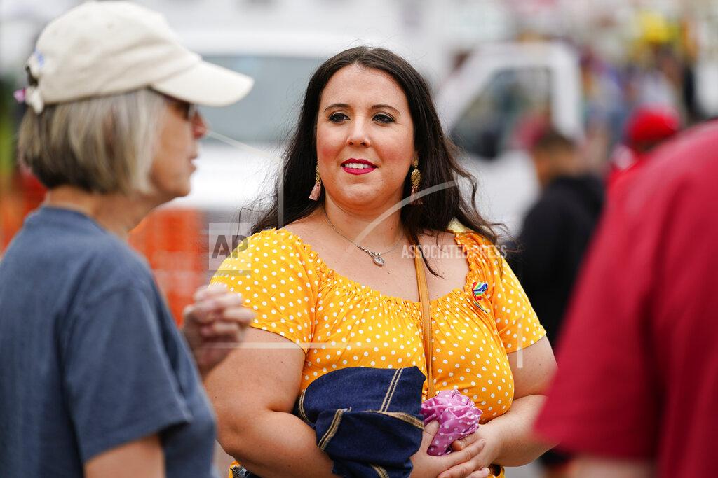 Matt Rourke Alicia Duque, a 35-year-old mother of three and volunteer organizer for the progressive group, Action Together listens to Claudia Glennan at the Edwardsville Pierogi Festival in Edwardsville, Pa., Friday, June 11, 2021. (AP Photo/Matt Rourke)
