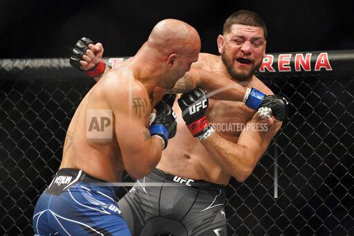 Robbie Lawler, left, throws a punch against Nick Diaz during a middleweight mixed martial arts bout at UFC 266, Saturday, Sept. 25, 2021, in Las Vegas. (AP Photo/John Locher)
