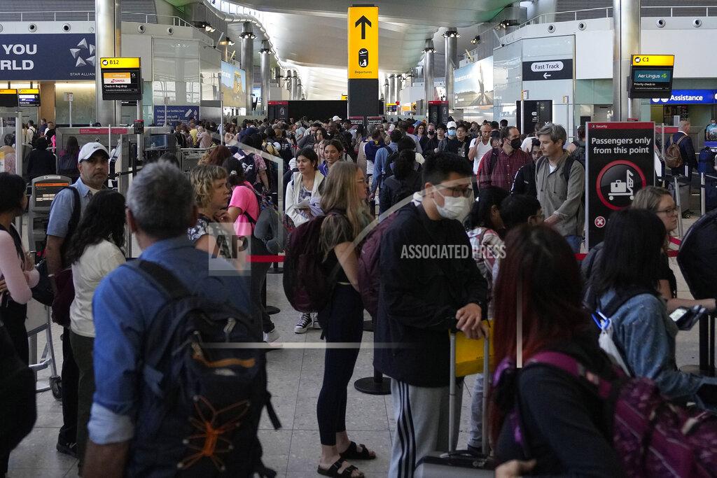 Frank Augstein Travellers queue at security at Heathrow Airport in London, Wednesday, June 22, 2022. After two years of pandemic restrictions, travel demand is back with a vengeance but airlines and airports that slashed jobs during the depths of the COVID-19 crisis are struggling to keep up. With the busy summer tourism season underway in Europe, passengers are encountering chaotic scenes at airports, including lengthy delays, canceled flights and headaches over lost luggage. (AP Photo/Frank Augstein)