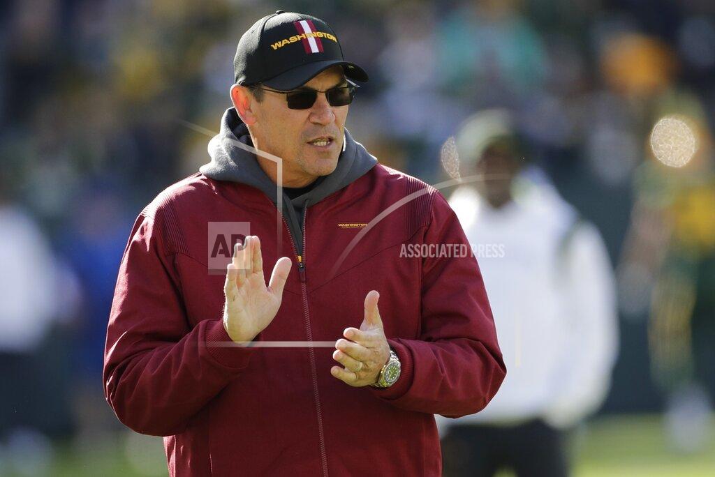 Aaron Gash FILE - Washington Football Team head coach Ron Rivera watches his team warm up before an NFL football game against the Green Bay Packers Sunday, Oct. 24, 2021, in Green Bay, Wis. Coaches Ron Rivera and Sean McDermott, standout players Christian McCaffrey, George Kittle and Demario Davis, team owner Arthur Blank, and the Houston Texans cheerleaders are among nominees from 31 teams for the NFL's Salute to Service Award. (AP Photo/Aaron Gash, File)