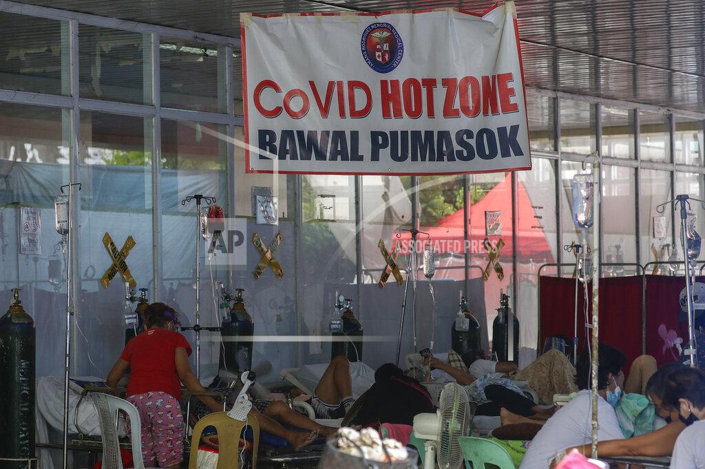Aaron Favila COVID-19 patients stay outside the Amang Rodriguez Memorial Medical Center emergency area as they wait for rooms to be vacated in Marikina, Philippines on Friday March 26, 2021. The Department of Health reported over 9,800 new COVID-19 cases today, the highest number since the pandemic hit the country last year as it struggles to contain an alarming surge in coronavirus infections. Sign reads "COVID Hot Zone, Do Not Enter." (AP Photo/Aaron Favila)