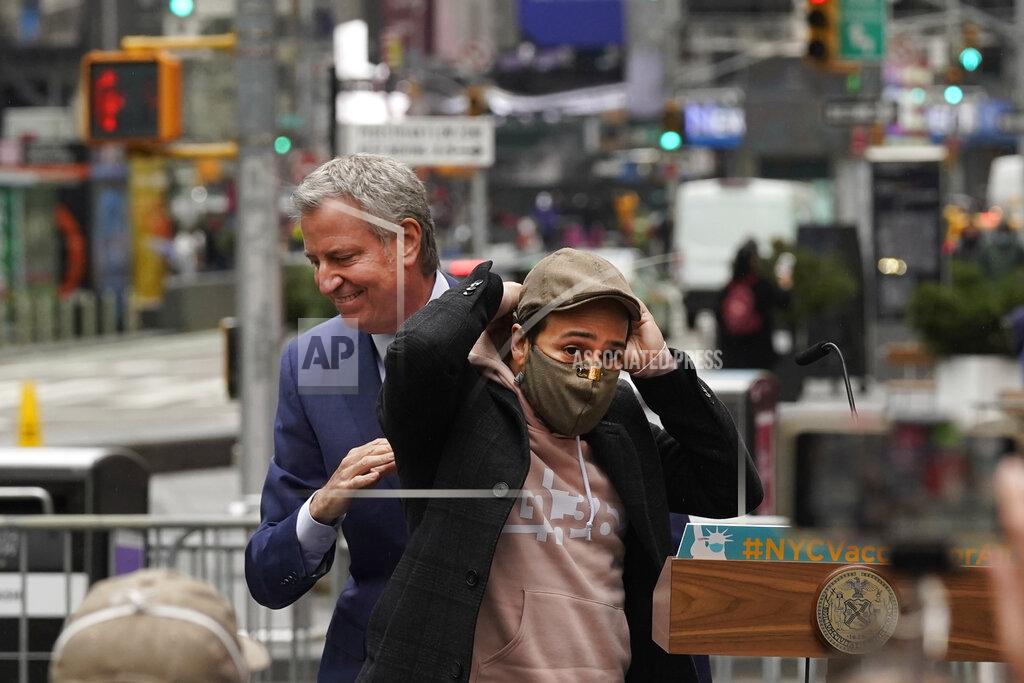 Richard Drew Actor Lin-Manuel Miranda, right, and New York Mayor Bill de Blasio, pass each other at the podium before Miranda's remarks in Times Square, after they toured the grand opening of a Broadway COVID-19 vaccination site intended to jump-start the city's entertainment industry, in New York, Monday, April 12, 2021. (AP Photo/Richard Drew)