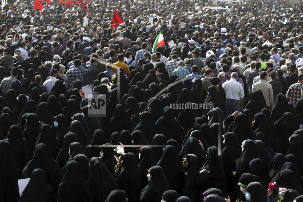 Vahid Salemi Mourners attend the funeral ceremony of Iran's Revolutionary Guard Col. Hassan Sayyad Khodaei in Tehran, Iran, Tuesday, May 24, 2022. Iran's hard-line President Ebrahim Raisi vowed revenge on Monday over the killing of Sayyad Khodaei who was shot at his car by two assailants outside his home in Tehran, a still-mysterious attack on the country's powerful paramilitary force. (AP Photo/Vahid Salemi)