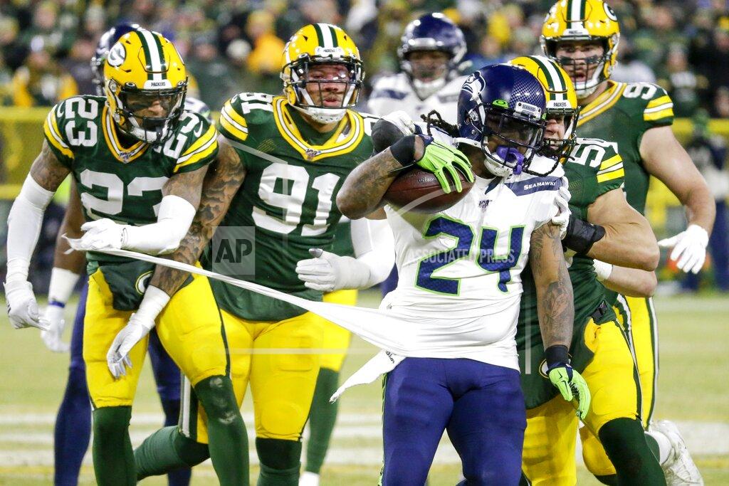 Mike Roemer Green Bay Packers' Jaire Alexander (23) and others try to stop Seattle Seahawks' Marshawn Lynch (24) during the first half of an NFL divisional playoff football game Sunday, Jan. 12, 2020, in Green Bay, Wis. (AP Photo/Mike Roemer)