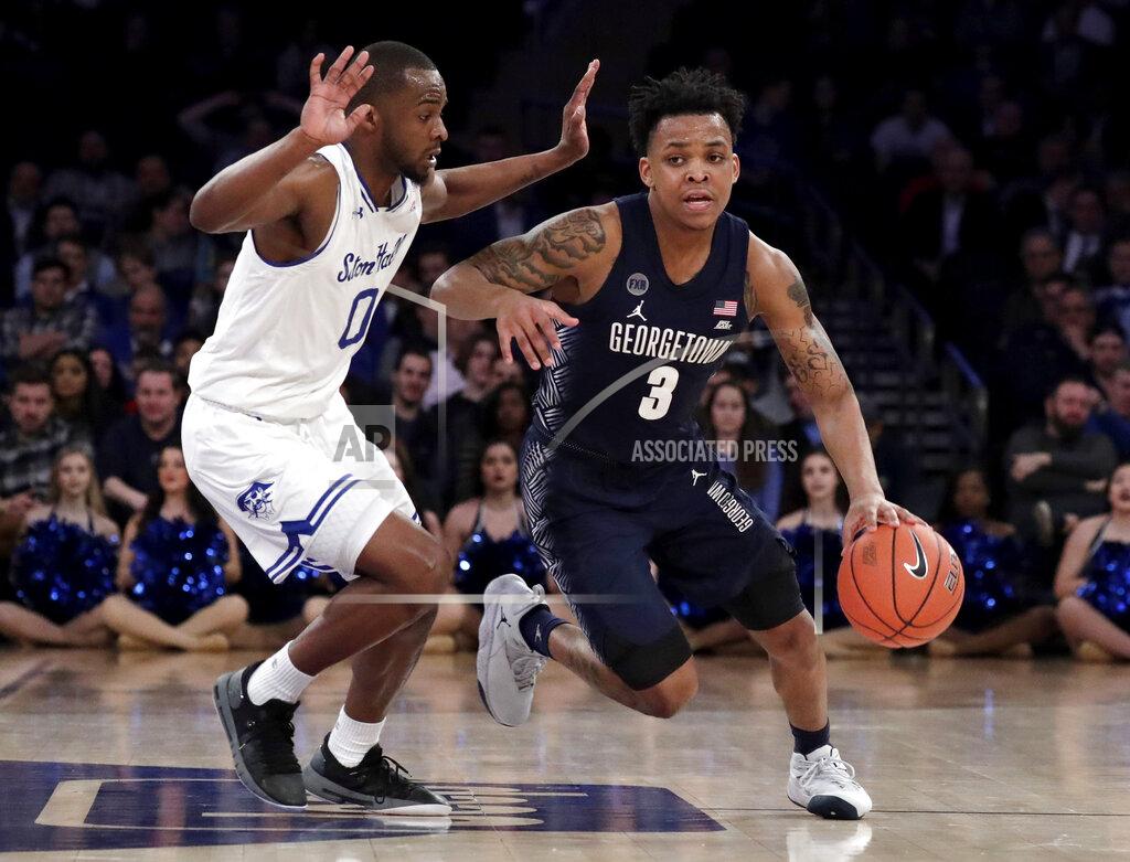 Julio Cortez Georgetown guard James Akinjo (3) drives against Seton Hall guard Quincy McKnight (0) during the second half of an NCAA college basketball game in the Big East men's tournament, Thursday, March 14, 2019, in New York. Seton Hall won 73-57. (AP Photo/Julio Cortez)