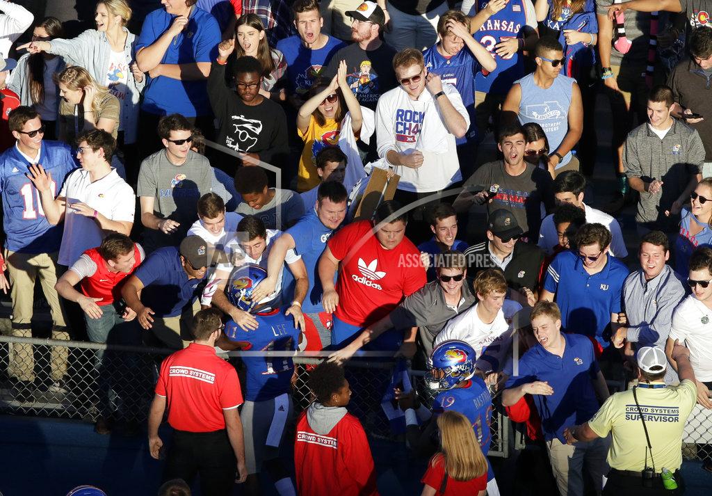 Orlin Wagner Kansas players Mike Lee (11) and Kenny Bastida (19) celebrate with fans following an NCAA college football game against TCU in Lawrence, Kan., Saturday, Oct. 27, 2018. (AP Photo/Orlin Wagner)