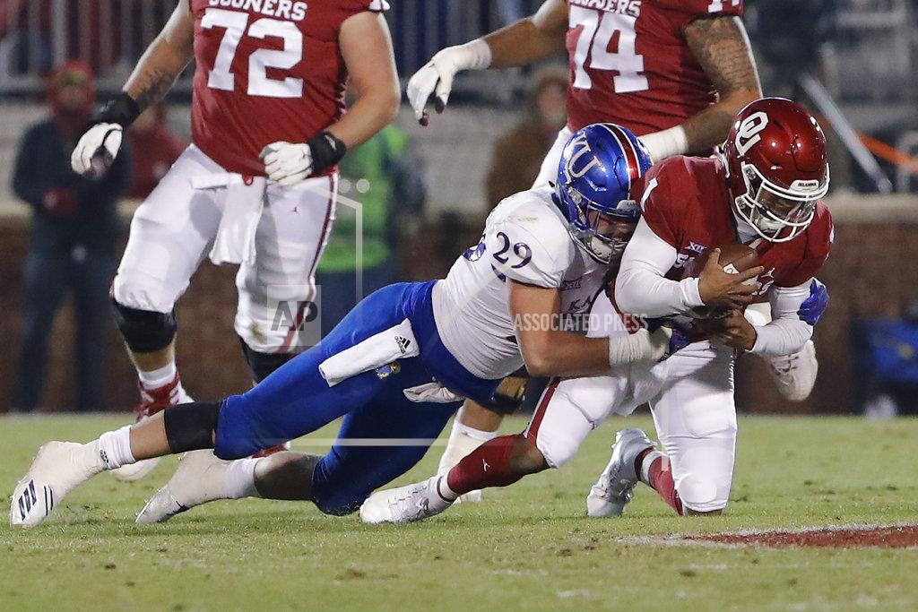 Alonzo Adams Kansas linebacker Joe Dineen Jr. (29) tackles Oklahoma quarterback Kyler Murray (1) during the first half of an NCAA college football game in Norman, Okla., Saturday, Nov. 17, 2018. (AP Photo/Alonzo Adams)