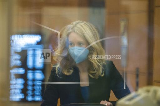 Elizabeth Holmes walks into federal court in San Jose, Calif., Monday, Nov. 22, 2021. Holmes is accused of duping elite financial backers, customers and patients into believing that her startup was about to revolutionize medicine. (AP Photo/Nic Coury)