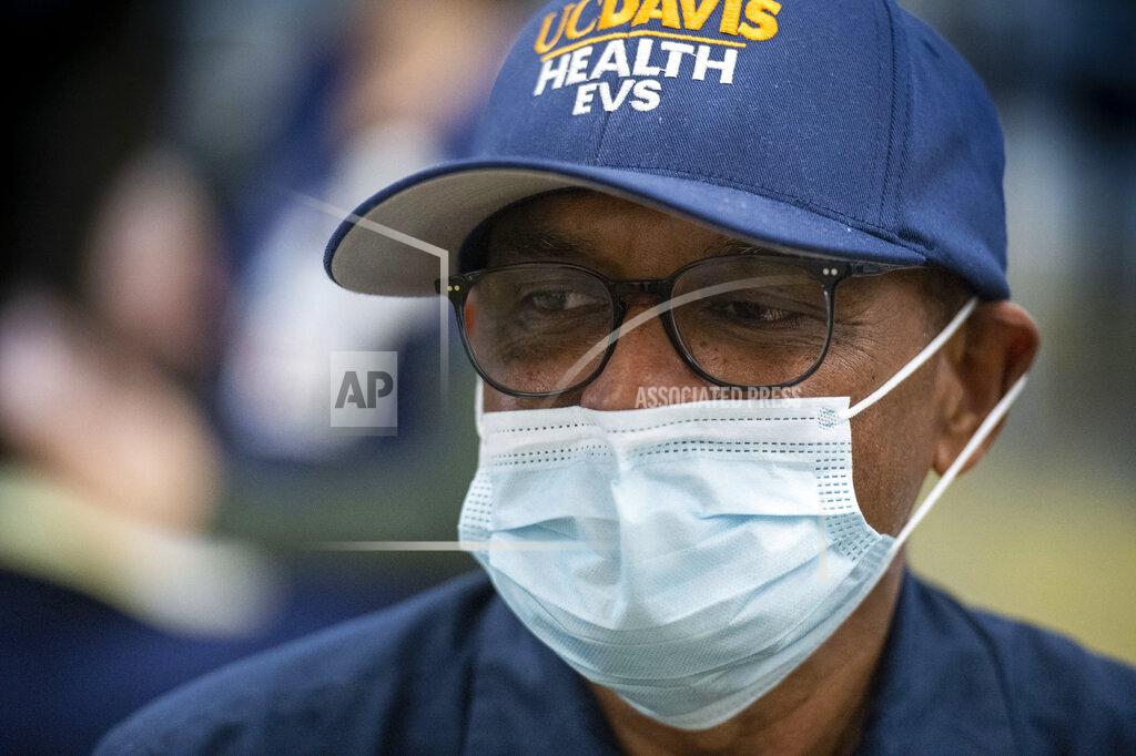Hector Amezcua Shashi Kant, UC Davis Medical Center custodian, waits to be cleared after being inoculated with the Pfizer-BioNTech COVID-19 vaccine, Tuesday, Dec. 15, 2020 in Sacramento, Calif. (AP Photo/Hector Amezcua, Pool)
