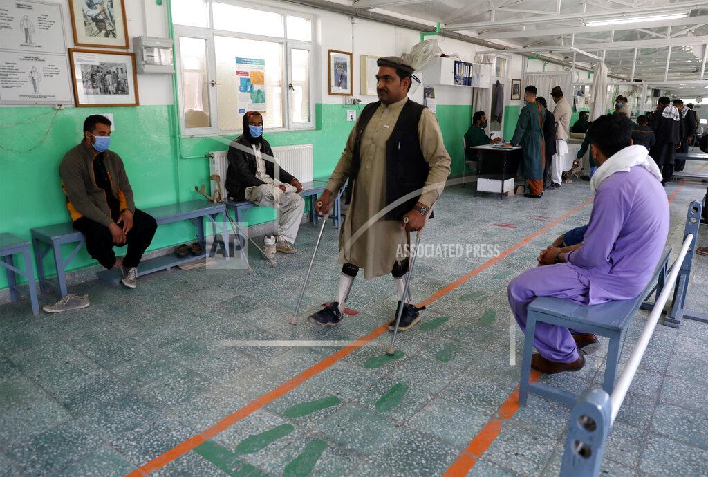 Rahmat Gul Afghan polio patient Maiwa Gul tests his new orthopedic devices at the International Committee of the Red Cross’ Orthopedic Program, in Kabul, Afghanistan, Monday, March 29, 2021. In 2020, nearly 5,000 polio patients received treatment at the program, including physiotherapy, medical equipment and orthopedic devices. (AP Photo/Rahmat Gul)