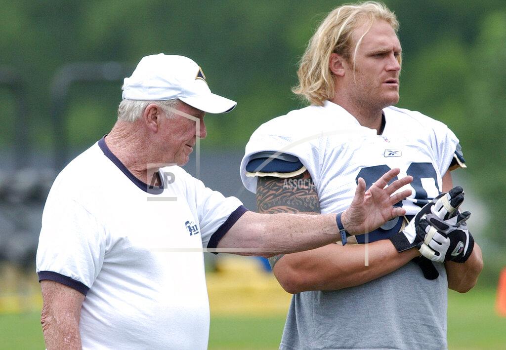 James A. Finley FILE - In this July 25, 2003, file photo, St. Louis Rams offensive line coach Jim Hanifan, left, works with Kyle Turley during NFL football training camp in Macomb, Ill. Hanifan, the former St. Louis Cardinals coach who returned to the city as offensive line coach to help the Rams win the Super Bowl, has died. He was 87. Hanifan’s daughter, Kathy Hinder, told the St. Louis Post-Dispatch that he died Tuesday, Nov. 23, 2020. She said the cause of death hasn't been determined, but said it wasn't related to COVID-19. (AP Photo/James A. Finley, File)