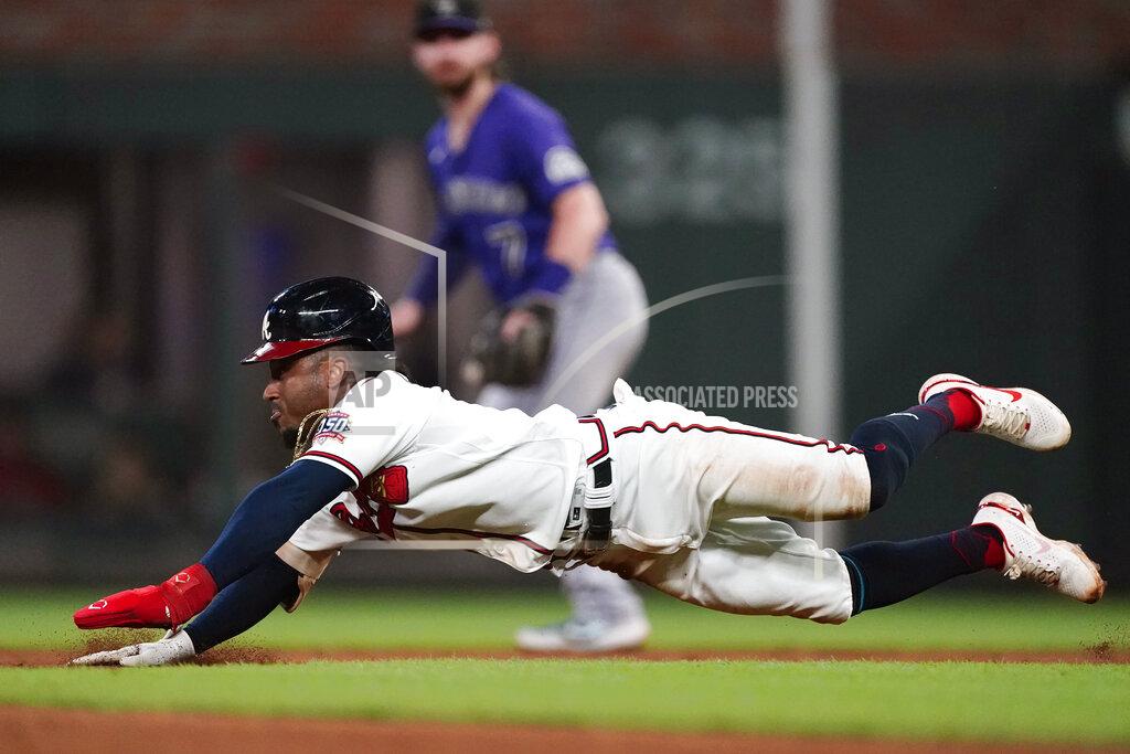 John Bazemore Atlanta Braves second baseman Ozzie Albies (1) slides into second before being tagged out in the fifth inning of a baseball game against the Colorado Rockies Tuesday, Sept. 14, 2021, in Atlanta. (AP Photo/John Bazemore)