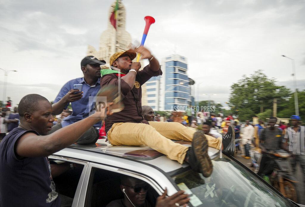 Uncredited People celebrate in the streets in the capital Bamako, Mali Tuesday, Aug. 18, 2020. Mutinous soldiers detained Mali's president and prime minister Tuesday after surrounding a residence and firing into the air in an apparent coup attempt after several months of demonstrations calling for President Ibrahim Boubacar Keita's ouster. (AP Photo)