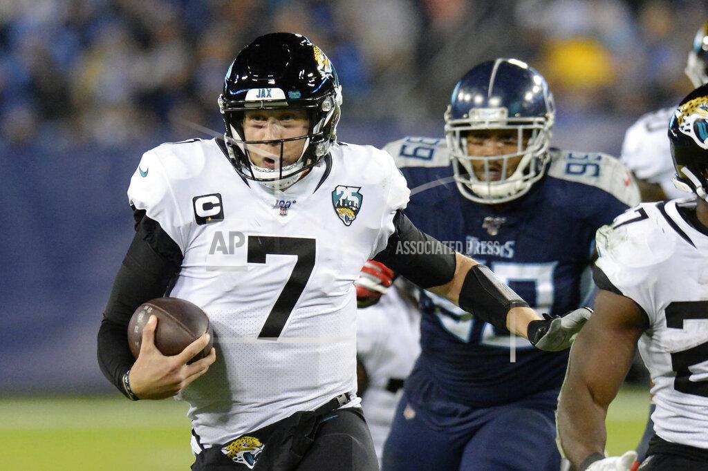 Mark Zaleski FLE - In this Nov. 24, 2019, file photo, Jacksonville Jaguars quarterback Nick Foles (7) scrambles against the Tennessee Titans in the second half of an NFL football game in Nashville, Tenn. A person familiar with the trade says the Jacksonville Jaguars have agreed to send quarterback Nick Foles to the Chicago Bears for a compensatory fourth-round draft pick. The person spoke to The Associated Press on condition of anonymity because trades don't become official until the league year begins later Wednesday, March 18, 2020. (AP Photo/Mark Zaleski, File)