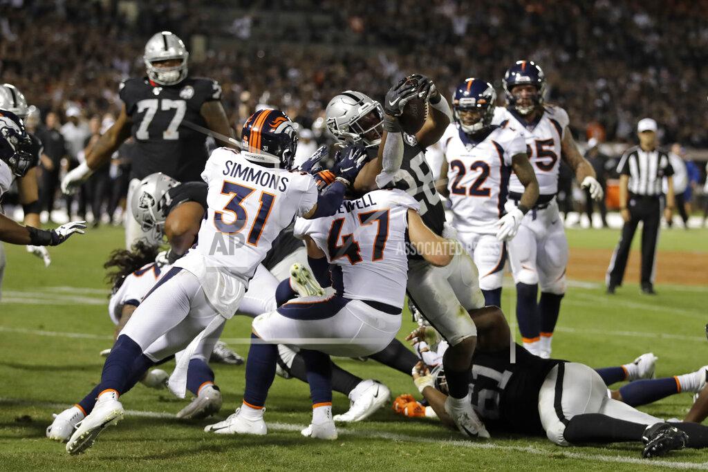 Ben Margot Oakland Raiders running back Josh Jacobs (28) scores a touchdown as Denver Broncos free safety Justin Simmons (31) and inside linebacker Josey Jewell (47) look on during the first half of an NFL football game Monday, Sept. 9, 2019, in Oakland, Calif. (AP Photo/Ben Margot)