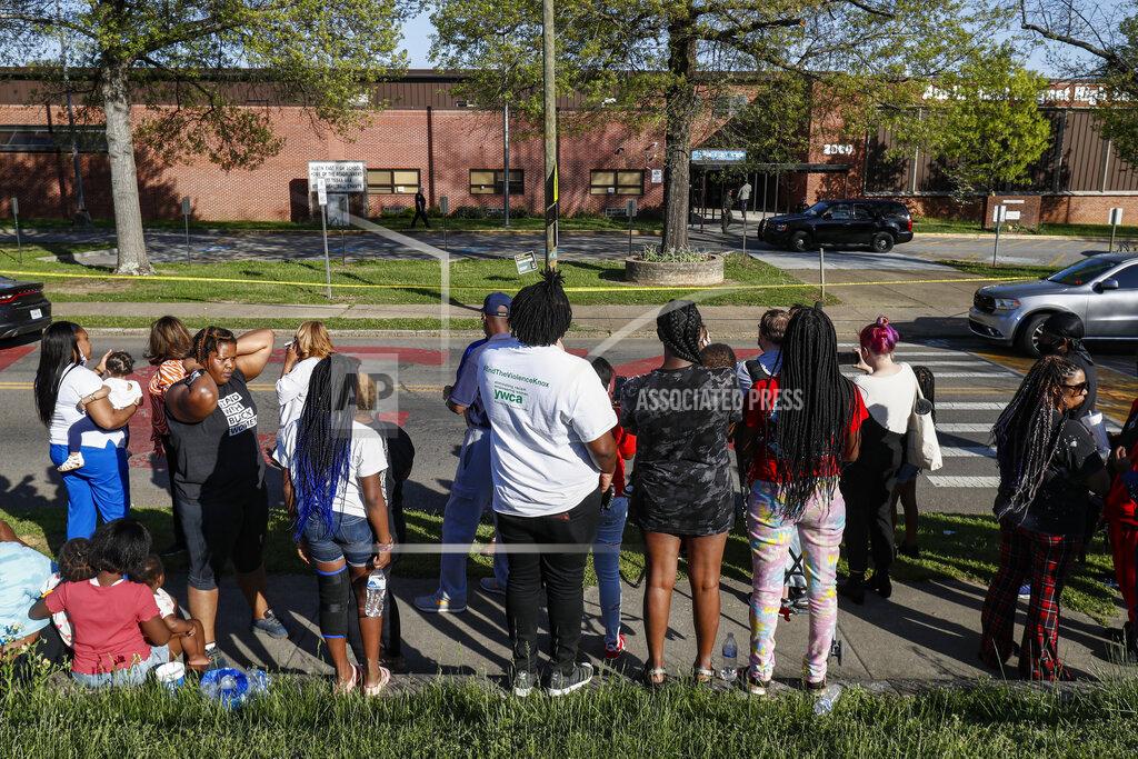 Wade Payne People look on as Knoxville police work the scene of a shooting at Austin-East Magnet High School Monday, April 12, 2021, in Knoxville, Tenn. (AP Photo/Wade Payne)