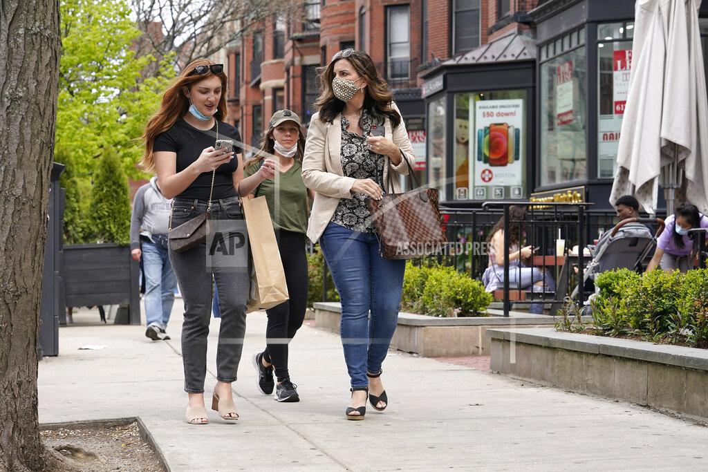 Steven Senne FILE - In this May 2, 2021, file photo, pedestrians walk along Boston's fashionable Newbury Street. COVID-19 deaths in the U.S. have tumbled to an average of just over 600 per day — the lowest level in 10 months — with the number of lives lost dropping to single digits in well over half the states and hitting zero on some days. (AP Photo/Steven Senne, File)