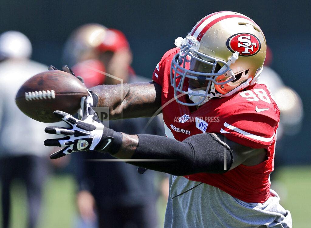 FILE - In this Aug. 12, 2013, file photo, San Francisco 49ers linebacker Parys Haralson reaches for the ball during NFL football training camp in Santa Clara, Calif. On Monday, Sept. 13, 2021, the San Francisco 49ers announced that Haralson, a former linebacker for the 49ers and New Orleans Saints, had died. He was 37. (AP Photo/Marcio Jose Sanchez, File)
