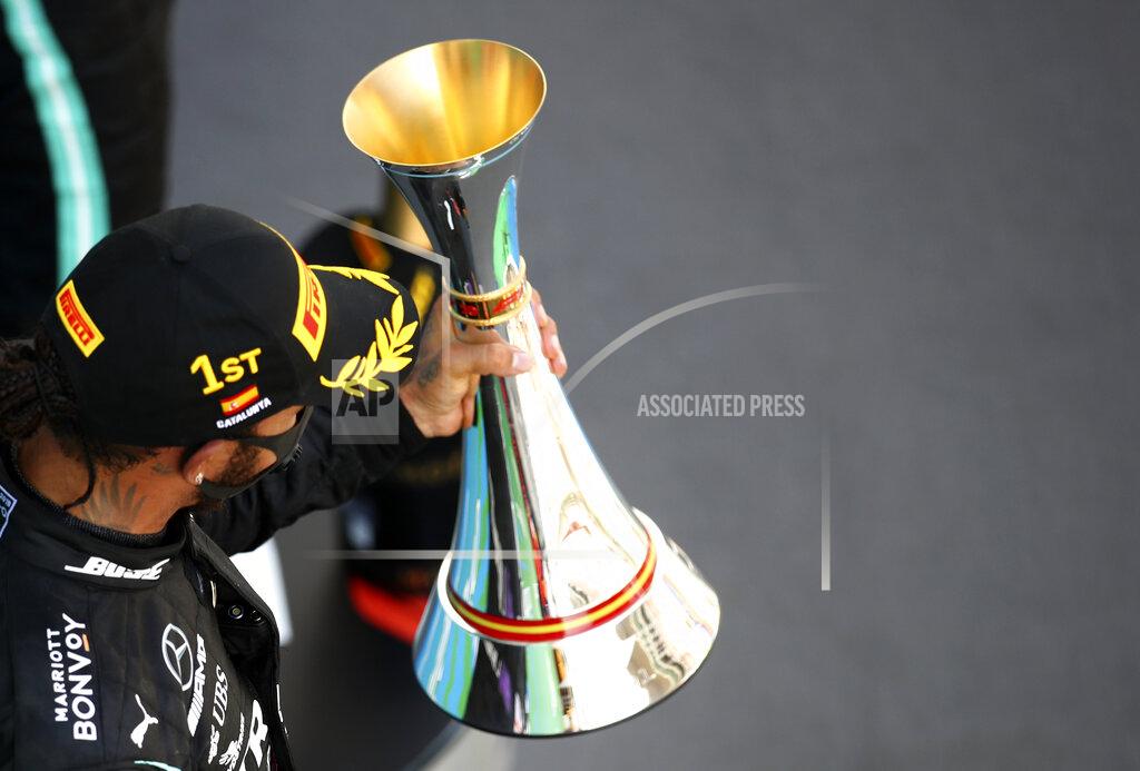 Bryn Lennon Mercedes driver Lewis Hamilton of Britain celebrates on the podium after winning the Formula One Grand Prix at the Barcelona Catalunya racetrack in Montmelo, Spain, Sunday, Aug. 16, 2020. (Bryn Lennon, Pool via AP)