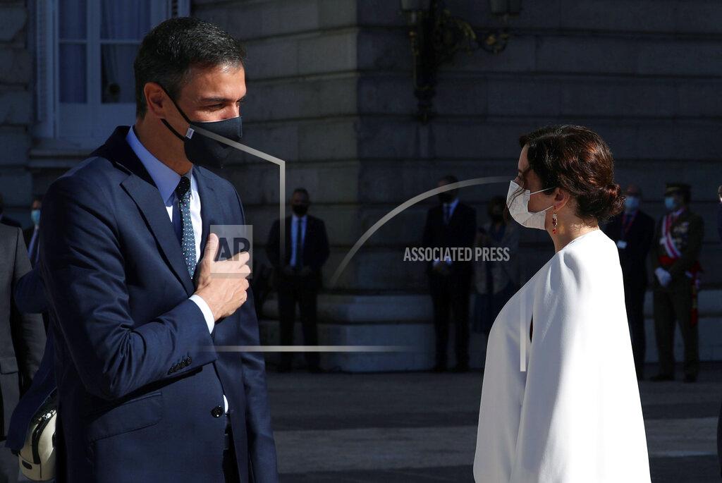 FILE - In this Monday, Oct. 12, 2020 file photo, Spain's Prime Minister Pedro Sanchez, left, welcomes Madrid's regional president Isabel Diaz Ayuso, center, and Madrid's mayor Jose Luis Martinez Almeida during an event to commemorate the 'Dia de la Hispanidad' or Spain's Hispanic Day in Madrid. Spain’s central region of Madrid will face snap elections after regional vice president Ignacio Aguado announced Wednesday, March 10, 2021 that its right-wing coalition government has dissolved. Aguado, of the liberal Citizens party, told Spanish media in an impromptu televised appearance that regional president Isabel Diaz Ayuso had decided to break up their coalition. (Kiko Huesca/Pool via AP, File)