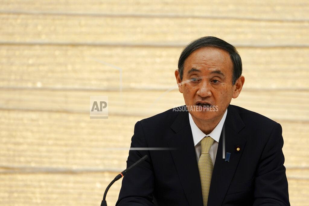 Japanese Prime Minister Yoshihide Suga declares a state of emergency for Tokyo and three other prefectures during the government task force meeting for the COVID-19 measures at the prime minister's office Friday, April 23, 2021, in Tokyo. (AP Photo/Eugene Hoshiko, Pool)