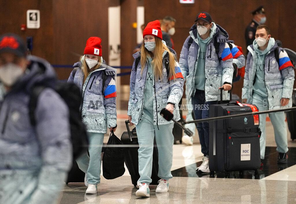 Pavel Golovkin Members of the Russian Olympic Committee team walk before their departure for the 2022 Winter Beijing Olympic Games in Moscow's Sheremetyevo airport, Russia, Wednesday, Jan. 26, 2022. (AP Photo/Pavel Golovkin)
