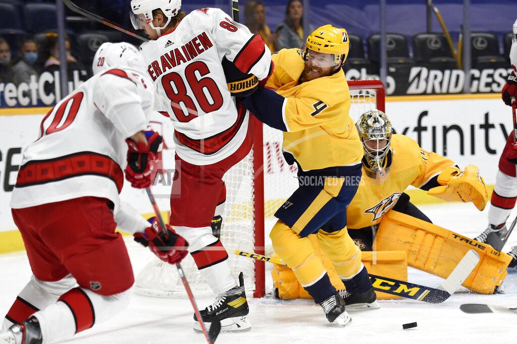 Mark Zaleski Nashville Predators defenseman Ryan Ellis (4) shoves Carolina Hurricanes left wing Teuvo Teravainen (86) away from the puck during the first period of an NHL hockey game Saturday, May 8, 2021, in Nashville, Tenn. (AP Photo/Mark Zaleski)
