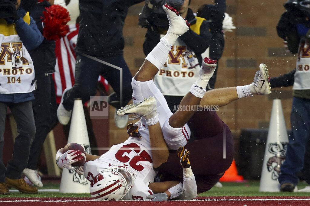 Stacy Bengs Wisconsin running back Jonathan Taylor (23) falls in the end zone for touchdown against Minnesota linebacker Carter Coughlin (45) during an NCAA college football game Saturday, Nov. 30, 2019, in Minneapolis. (AP Photo/Stacy Bengs)