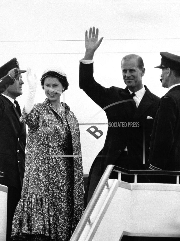 Uncredited FILE - In this file photo dated June 18, 1959, Prince Philip waves as he and Queen Elizabeth II stand at top of plane ramp at London Airport, prior to their departure by jet airliner for 45-day tour of Canada. Prince Philip who died Friday April 9, 2021, aged 99, lived through a tumultuous century of war and upheavals, but he helped forge a period of stability for the British monarchy under his wife, Queen Elizabeth II. Philip helped create the Commonwealth of nations, with the queen at its head, in an attempt to bind Britain and its former colonies together on a more equal footing. (AP Photo, FILE)